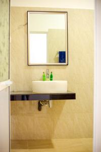 a bathroom with a sink and a mirror at The Blue Haze Weligama in Weligama