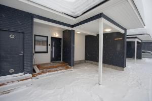 a house is covered in snow with a roof at Beautiful and peaceful home near Levi center in Kittilä +10 photos
