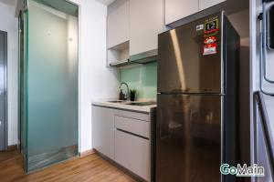 a kitchen with a stainless steel refrigerator at 24h Check in & SkyPool- KL Sentral Suite Riveria City Near KL Sentral KL KLCC in Kuala Lumpur