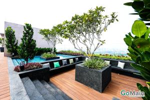 a patio with plants and a pool on a building at 24h Check in & SkyPool- KL Sentral Suite Riveria City Near KL Sentral KL KLCC in Kuala Lumpur