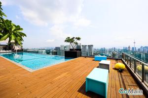 a balcony with a swimming pool on top of a building at 24h Check in & SkyPool- KL Sentral Suite Riveria City Near KL Sentral KL KLCC in Kuala Lumpur