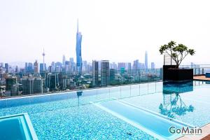 a swimming pool with a view of the city at 24h Check in & SkyPool- KL Sentral Suite Riveria City Near KL Sentral KL KLCC in Kuala Lumpur