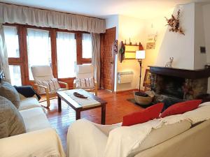 a living room with two couches and a fireplace at Arties III in Arties