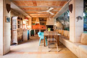 a kitchen with a table and chairs and a ceiling fan at CASA ANITA 4 pax in Ses Salines