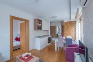 a room with a kitchen and a dining room at Egoiste Guesthouse Zlatibor Center in Zlatibor +58 photos