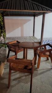 a table and a bench and a table and a chair at Kopap Villa in Lalonggasumeto