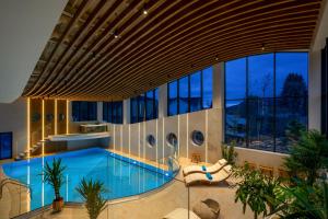 a large swimming pool in a building at Hotel Valedor Boutique & Spa in Buşteni