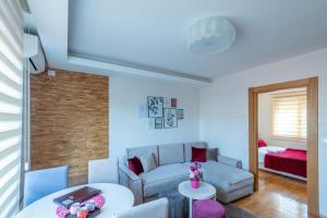 a living room with a couch and a table at Egoiste Guesthouse Zlatibor Center in Zlatibor