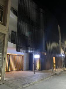 a building with a gate and a parking meter at Alinea Market Agora Square in Limassol