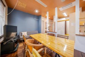 a dining room with a large wooden table and chairs at Minowa airbnb in Yubari