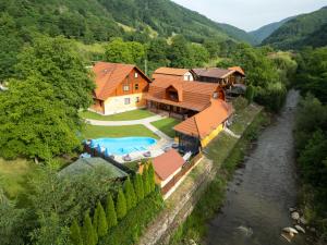 an aerial view of a house with a swimming pool at Cabana Sargetia in Costeşti