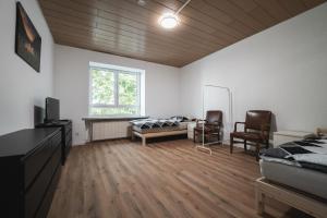 a bedroom with a bed and a desk and chairs at Gästezimmer Kalb in Schweinfurt