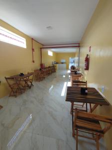 a room with wooden tables and chairs in it at Karajás Hotel in Quixeramobim