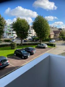 a view of cars parked in a parking lot at Bel appartement spacieux ,convivial de 3 chambres avec parking privé sécure in Caen