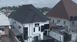an overhead view of a white house with a brown roof at Keneuro hotel & suites in Lagos