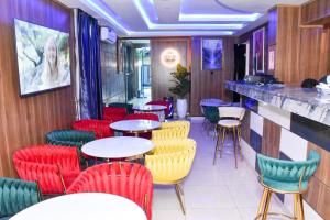 a restaurant with red and yellow chairs and tables at Keneuro hotel & suites in Lagos