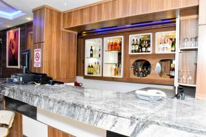 a bar in a hotel room with alcohol bottles at Keneuro hotel & suites in Lagos