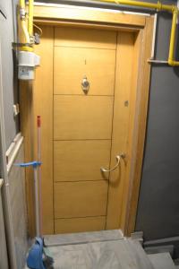a wooden door in the middle of a room at Huzur 1 in Edirne