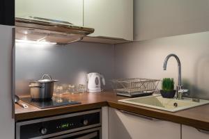 a kitchen with a sink and a stove top oven at Villa Velvet in Villeneuve-Loubet