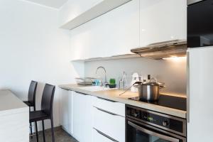 a kitchen with a sink and a stove top oven at Villa Velvet in Villeneuve-Loubet