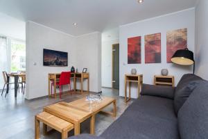 a living room with a couch and a table at Villa Velvet in Villeneuve-Loubet