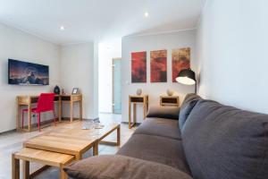 a living room with a couch and a table at Villa Velvet in Villeneuve-Loubet
