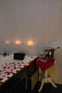 a room with a table with red roses on it at Cabecera Country Hotel in Bucaramanga