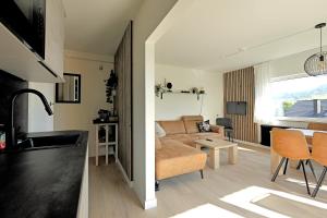 a kitchen and living room with a couch and a table at Ferienwohnung beim Skihang in Willingen