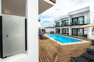 a view of the pool and deck of a house at Saladar Suites Boutique in Morro del Jable
