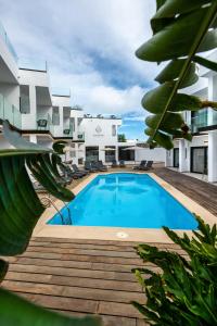 a large swimming pool in front of a building at Saladar Suites Boutique in Morro del Jable