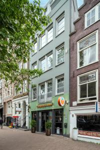 a row of buildings on a city street at Tourist Inn Hotel Amsterdam in Amsterdam