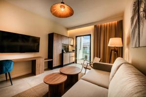 a living room with a couch and a tv at Saladar Suites Boutique in Morro del Jable