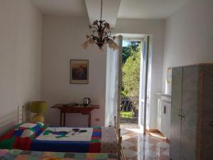 a bedroom with a bed and a sliding glass door at Villa Gildanna2 in Orio Litta