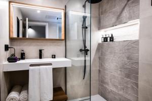 a bathroom with a sink and a shower at Saladar Suites Boutique in Morro del Jable