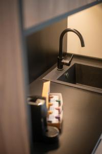 a bathroom sink with a faucet and aaucet at Saladar Suites Boutique in Morro del Jable