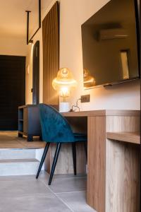 a desk with a blue chair in a room at Saladar Suites Boutique in Morro del Jable