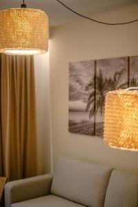 a living room with a couch and a chandelier at Saladar Suites Boutique in Morro del Jable