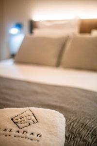 a close up of a hotel tag on a bed at Saladar Suites Boutique in Morro del Jable