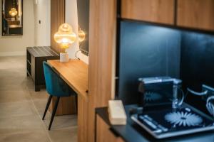 a room with a desk with a laptop and a lamp at Saladar Suites Boutique in Morro del Jable