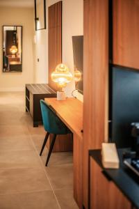 a room with a desk with a chair and a lamp at Saladar Suites Boutique in Morro del Jable