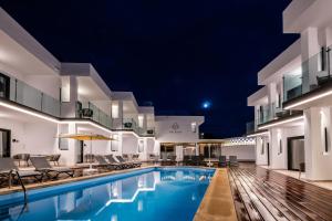 a view of the pool of a hotel at night at Saladar Suites Boutique in Morro del Jable