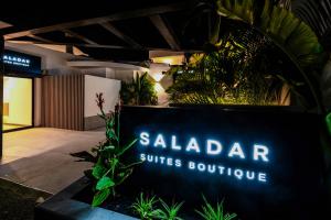 a sign that reads saladin surfaces boutique at Saladar Suites Boutique in Morro del Jable