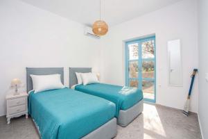 two beds in a white room with a window at Villa Kalathos Dream White in Kalathos +16 photos