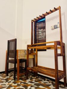 a room with a table and a chair and a desk at Cozy Sand Beach Hotel in Arugam Bay