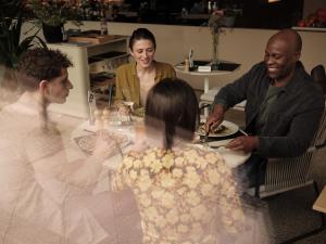 a group of people sitting around a table eating food at Casa Camper Berlin in Berlin
