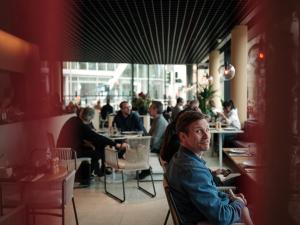 a group of people sitting in a restaurant at Casa Camper Berlin in Berlin