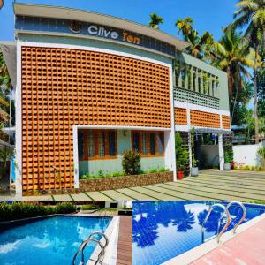 a hotel with a swimming pool in front of it at Clive Ten Resorts Athirapilly in Kizhake Chālakudi