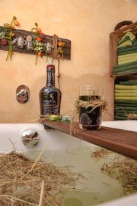 a bottle of alcohol sitting on a shelf in a bath tub at Landhaus Brodack in Alt Zauche