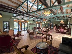 a large room with tables and chairs in a room with windows at Anapea Village in Tkhilistskaro