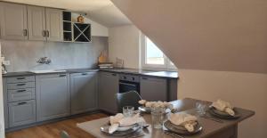 a kitchen with a table with dishes on it at Ferienwohnung Macht in Furth im Wald